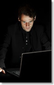 man-at-computer-dark