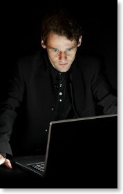 man-at-computer-dark